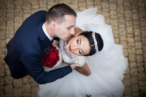 Romantic Shot Of Newlywed Husband And Wife Hugging On Old Staircase