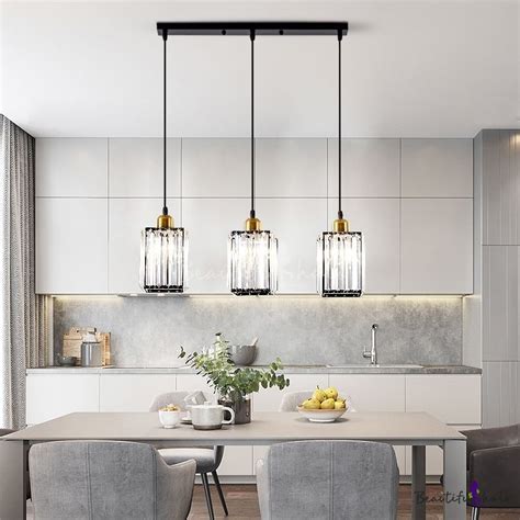 dining room table   chairs   pendant lights hanging   kitchen island