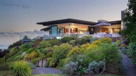 zealand home perched   promontory surrounded  beaches