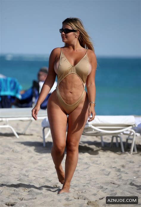 anastasia kvitko sexy in a gold swimsuit with thong bottoms at the