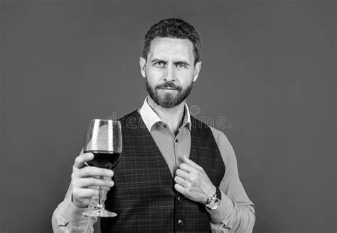 Handsome Man In Formal Wear Hold Glass Of Red Wine For Drinking Cheers