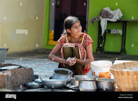 Teenage Indian Girl Washing Dishes Outside Her Rural Indian Village