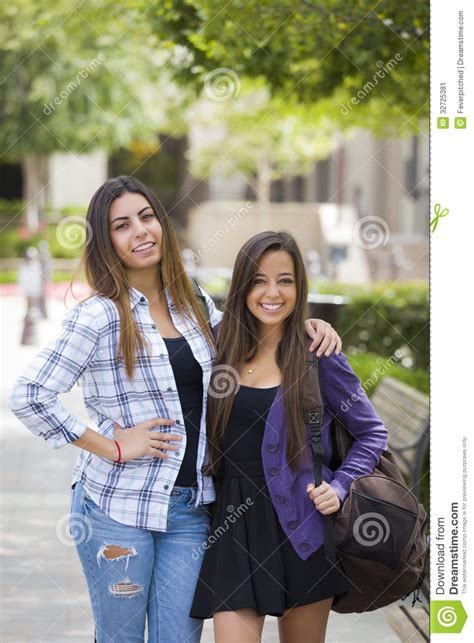 mixed race female couple carrying backpacks on school campus stock image image 32725381
