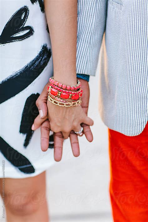 close up of a couple holding hands outdoors by kristen curette hines stocksy united