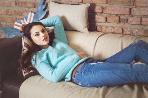 Pretty Brunette Girl Relaxing On The Couch At Home Stock Image Image