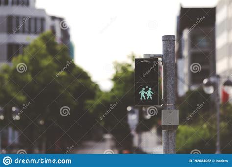 a pedestrian traffic light shows a green graphic of a