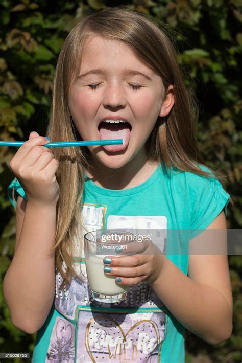 Portrait Of Girl Licking Milk From Drinking Straw Photo Getty Images