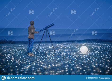 guy with telescope under the sky in nature photoshoot portrait stock