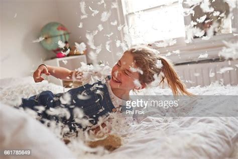 Girl Falling On Feather Pillow Fight Bed Photo Getty Images