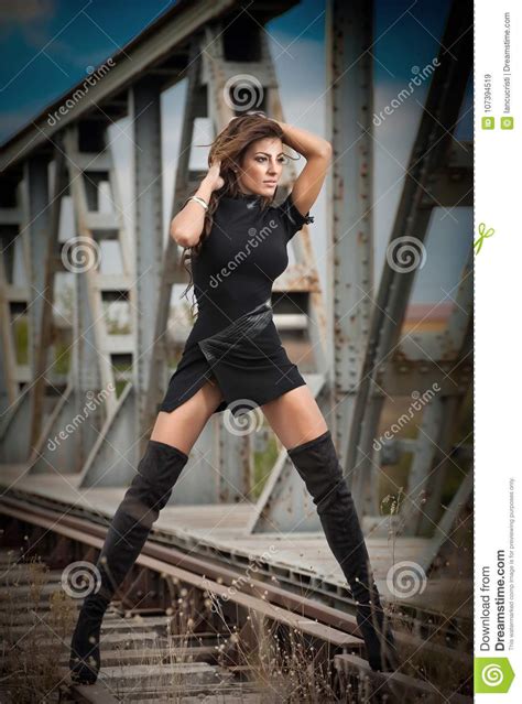 Attractive Woman With Short Black Dress And Long Leather
