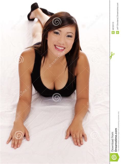 Smiling Asian American Teen Girl On Stomach Stock Image