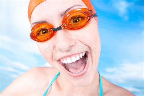 A Winner Young Cheerful Female Swimmer In An Orange Swimming Cap And