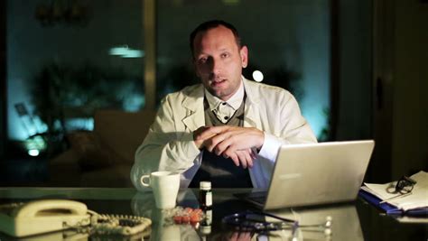 Doctor Talking To Camera At Night In Office Stock Footage