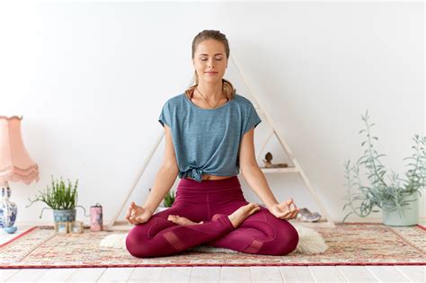 woman meditating  lotus pose  yoga studio ralph smart infinite
