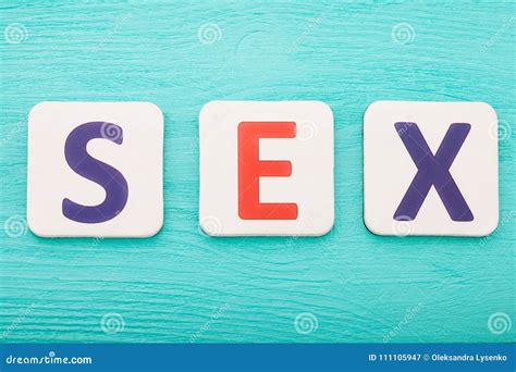 sex word by letter blocks on blue wooden background top view copy