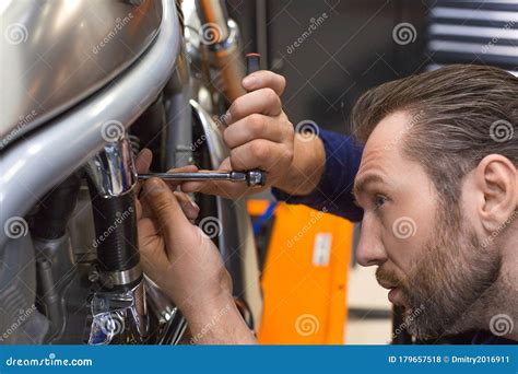 photo   man fixing    mechanical workshop stock photo
