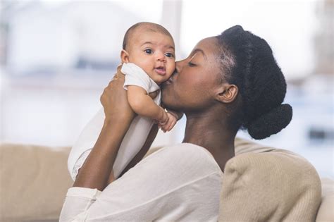 beautiful ethnic mom holds her infant girl gwinnett newton rockdale