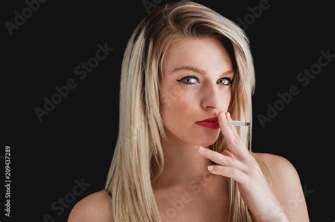 Blonde Woman Portrait Wearing Eyeliner And Red Lipstick And Smoking