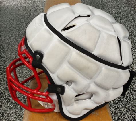 football team adopts  protective headgear  advocate