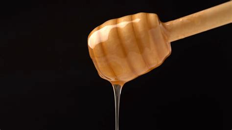 Footage Organic Honey Dripping From Wooden Honey Spoon On Black