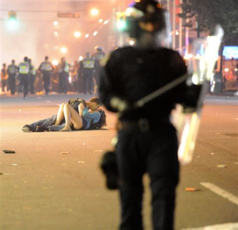 vancouver riot couple pictured kissing in middle goes