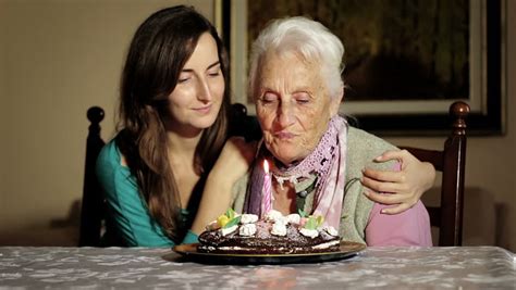 happy smiling grandmother celebrating and giving a birthday cake to her grandson stock footage
