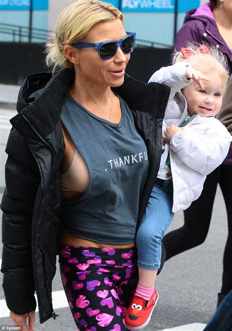 tracy anderson flashes her bra in skimpy top paired with flashy leggings as she carries daughter