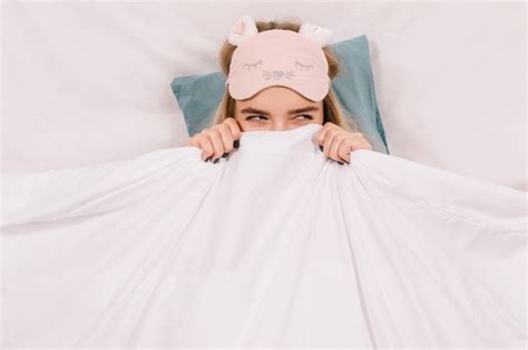Free Photo Adorable Woman In Sleep Mask Posing In Bed
