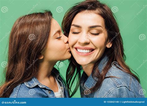 underbar dotter kysser lycklig mor och kinar isolerad arkivfoto bild