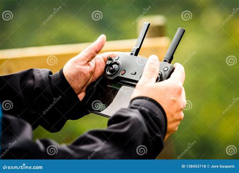 hand holding drone quadcopter uav remote control console controls stock photo image