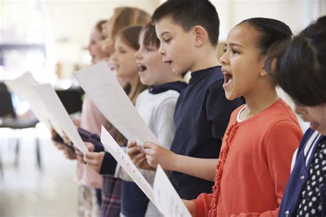 group  school children singing  choir   centre  young musicians