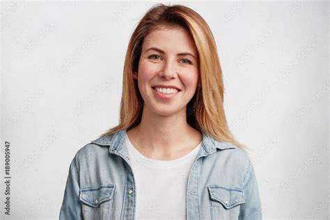 good looking female has toothy smile being glad to hear good news