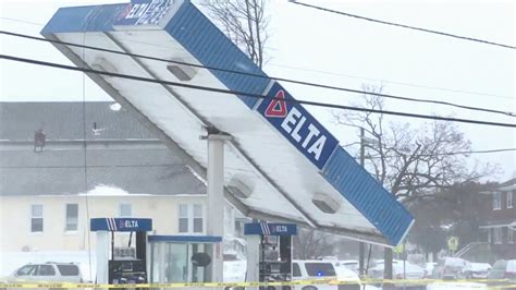 video gas station roof topples  due  powerful winds