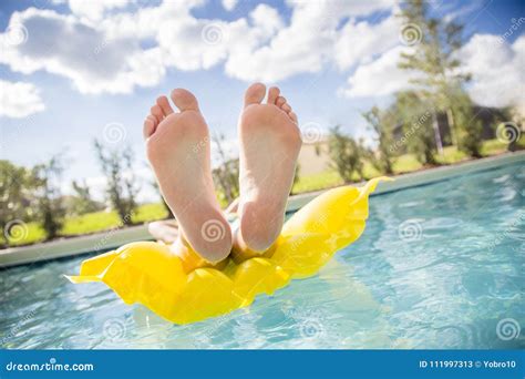Beautiful Feet And Toes Floating In The Swimming Pool Stock Image
