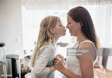 mother daughter kiss lips photos et images de collection getty images