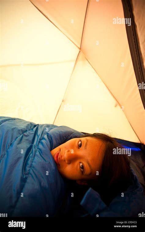 A Young Woman Wakes Up While Camping In Jasper Provincial Park Alberta