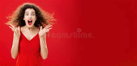 portrait of surprised and astonished speechless curly haired woman in