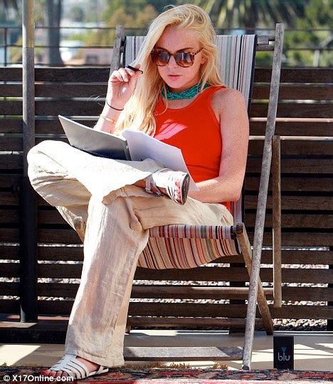 lindsay lohan catches up on scripts while puffing on an electronic