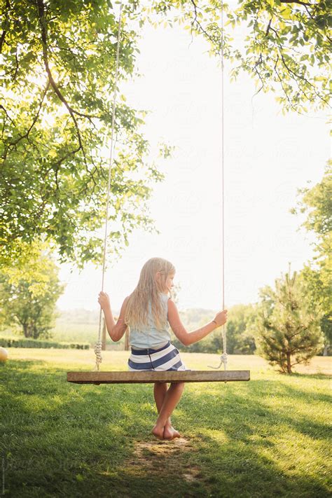 «blonde Girl Sitting On A Swing Del Colaborador De Stocksy «lumina
