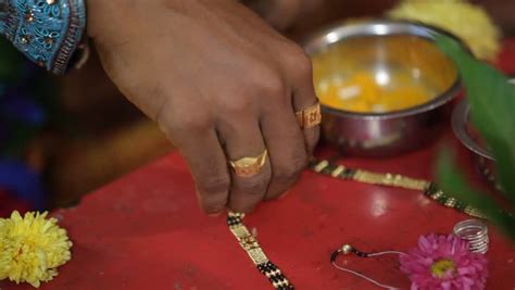 shot of indian bride and groom in traditional wedding dress under a