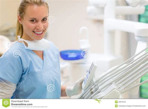 female dentist with dental equipment at surgery stock