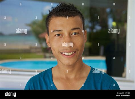 young smiling thai guy   camera phuket thailand stock photo alamy