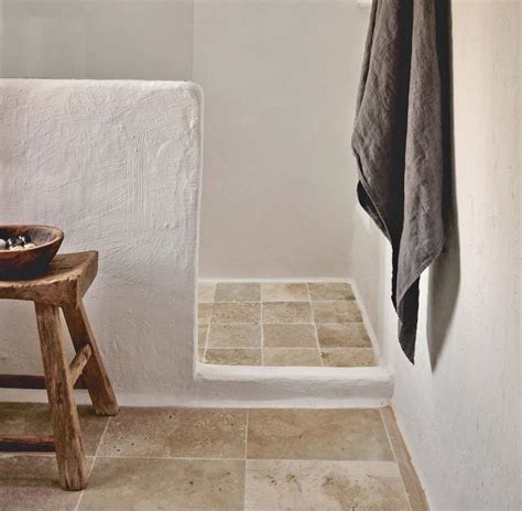 loving  bathroom  white venetian plaster walls  travertine tile floors  unfilled