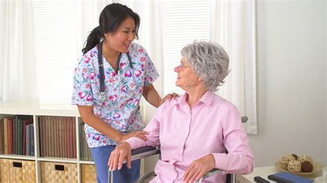 Japanese Nurse Talking With Mature Caucasian Patient Stock Video