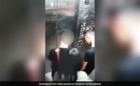 two man take piss on elevator while female friend tries to block cctv