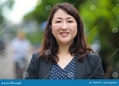 Mature Happy Beautiful Asian Businesswoman Smiling In The Streets