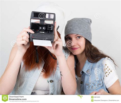 beauty hipster girls black and red in sunglasses making photo on camera snapshots teenagers