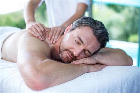 Man Receiving Back Massage From Masseur In Spa Stock