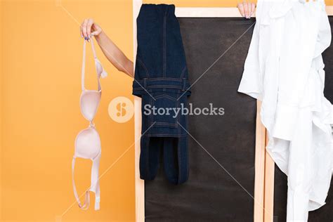 Woman Standing Behind Folding Screen And Taking Off Her Bra Royalty