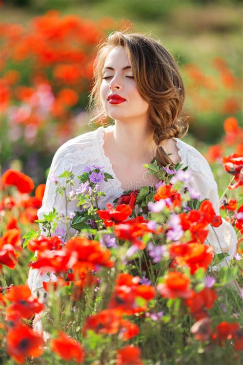 Pretty Woman In Field Of Red Poppy Flowers Spring Time Stock Image